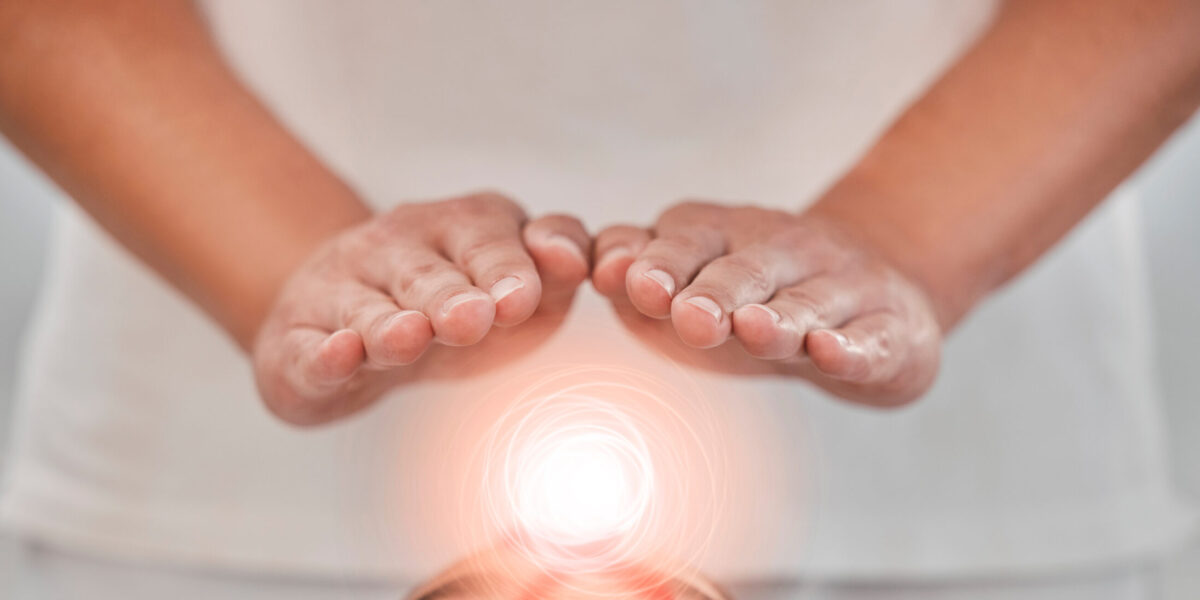 Hands, light energy and chakra healing for spa healthcare and luxury wellness. Woman palm, reiki therapy and spiritual aura expert or healthy power balance for calm lifestyle with body wellbeing.